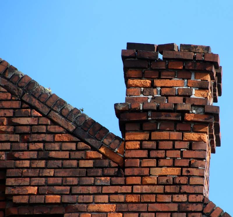 Damaged chimney on an Porter Ranch home showing cracks and missing mortar
